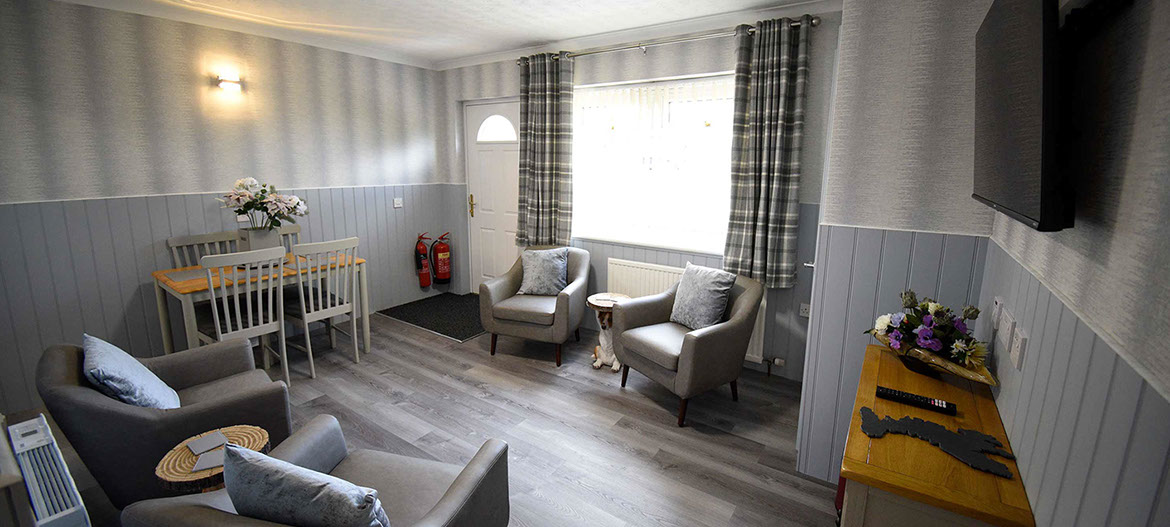 Quiraing House Self Catering accommodation living room with comfortable seating and widescreen TV