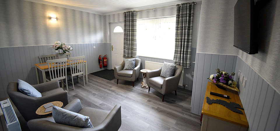 Quiraing House Self Catering accommodation living room with comfortable seating and widescreen TV