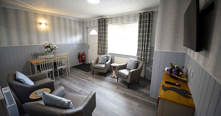 Quiraing House Self Catering accommodation living room with comfortable seating and widescreen TV